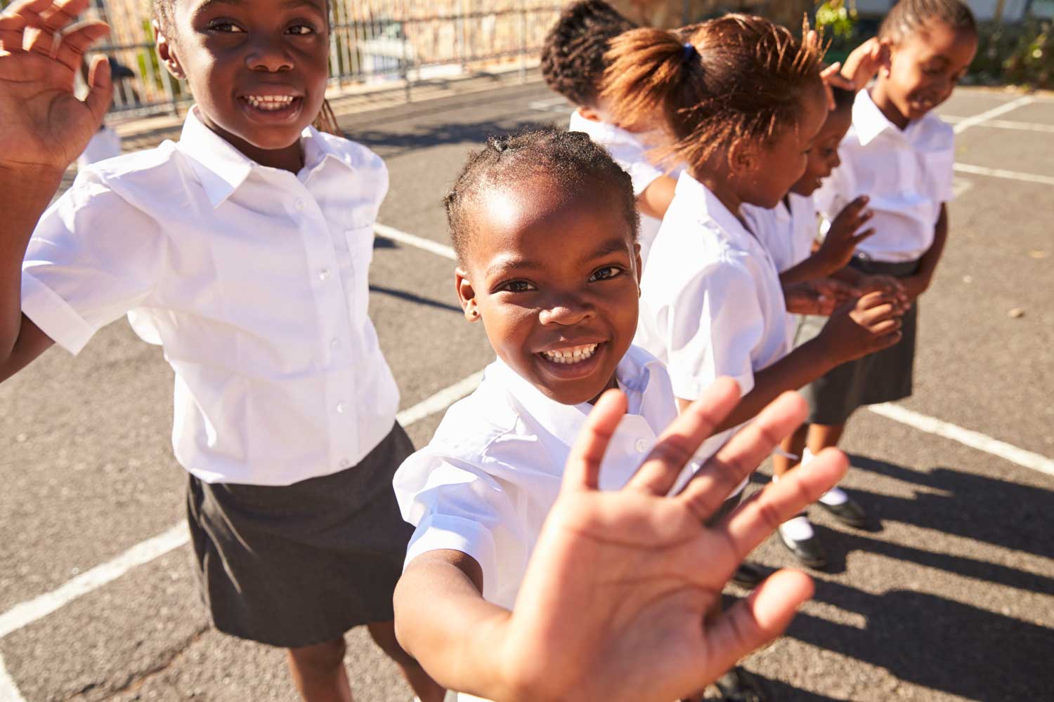 Young African Schoolgirls Playground Waving Camera